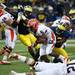 Michigan defensive end Mario Ojemudia tackles Illinois running back Josh Ferguson on Saturday. Daniel Brenner I AnnArbor.com
